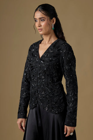 Three-quarter view of the black V-neck jacket with sequin paisley cutwork and full sleeves by Asaga at Mrs. G