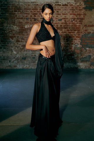 Three-quarter view of the black satin saree with the sash falling along the arm by Asaga at Mrs. G