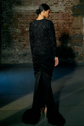 Back view of the black embroidered jacket and the ruched skirt trailing into a train by Asaga at Mrs. G