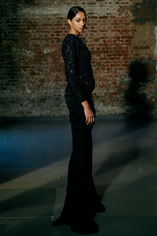 Side view of the black fitted jacket and the ruched fishtail skirt silhouette by Asaga at Mrs. G
