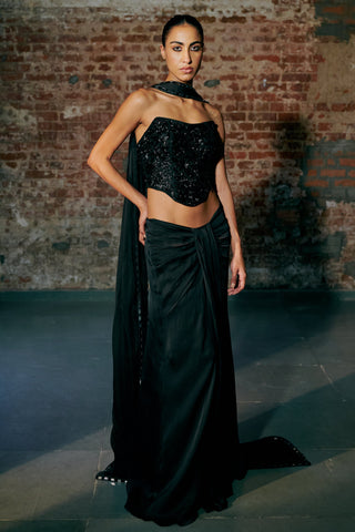 Front view of the black strapless beaded corset with the knotted drape skirt and mirror-trim dupatta by Asaga at Mrs. G
