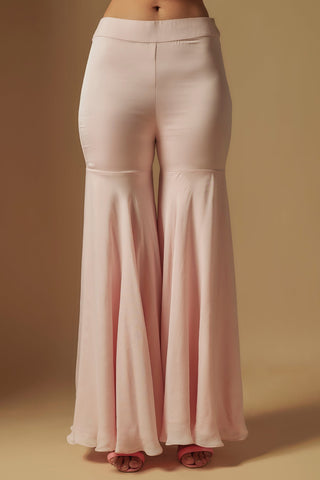 Waist-down view of blush flared satin sharara with knee panels and a fitted waistband by Asaga at Mrs. G