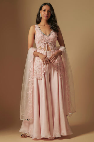 Front view of a blush floral embroidered short kurti with a flared satin sharara and a sequin net dupatta by Asaga at Mrs. G