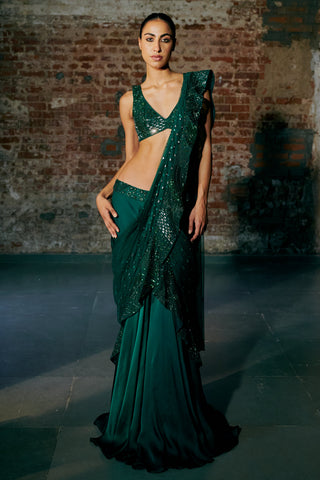 Front view of an emerald green pre-draped saree with a mirror-work blouse and a ruffled pallu by Asaga at Mrs. G
