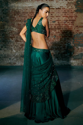 Back view of the emerald green saree with the pallu trailing and the braided hair by Asaga at Mrs. G