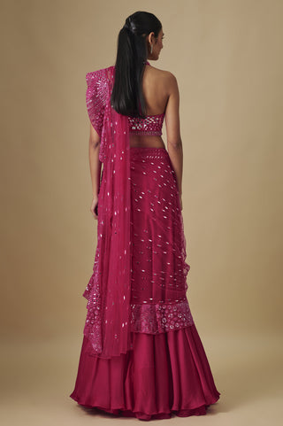 Back view of the fuchsia halter blouse and pallu falling over the flared satin skirt by Asaga at Mrs. G