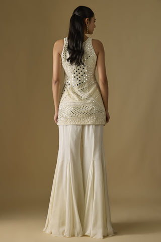 Close-up of the ivory satin sharara with godet panels flaring from the hip by Asaga at Mrs. G