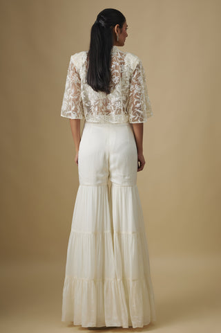Back view of the ivory floral net cape and tiered sharara by Asaga at Mrs. G