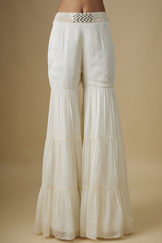 Close-up of the ivory tiered sharara with a square mirror waistband by Asaga at Mrs. G