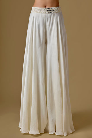 Detail of the ivory wide-leg satin sharara with a mirror work waistband by Asaga at Mrs. G