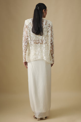 Back view of the ivory floral embroidered net cape and draped satin skirt by Asaga at Mrs. G