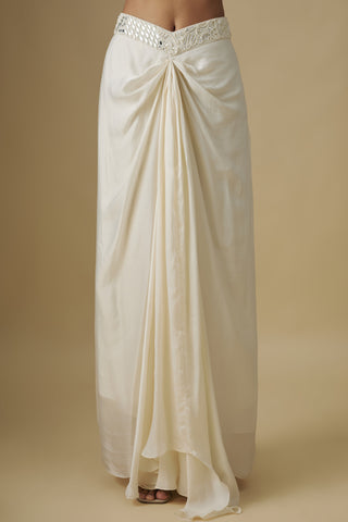 Close-up of the ivory draped satin skirt with a front knot and a mirror waistband by Asaga at Mrs. G