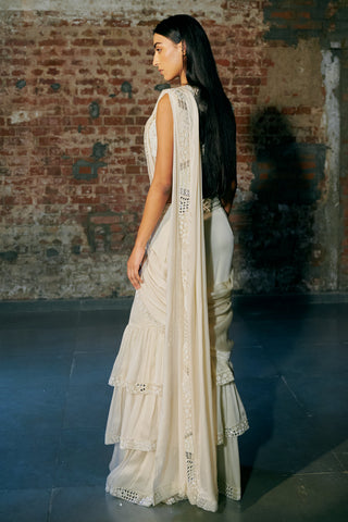 Side view of the ivory saree showing the pallu trailing behind and the ruffled tiers by Asaga at Mrs. G