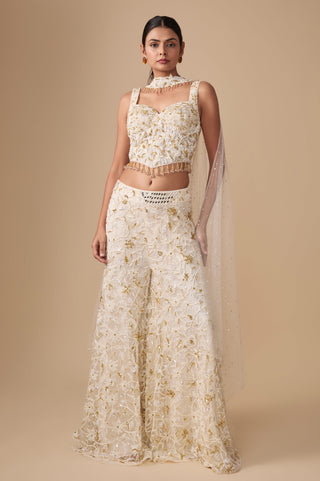 Full-length front view of the ivory gold sweetheart corset blouse, floral jaal sharara and choker net dupatta by Asaga at Mrs. G
