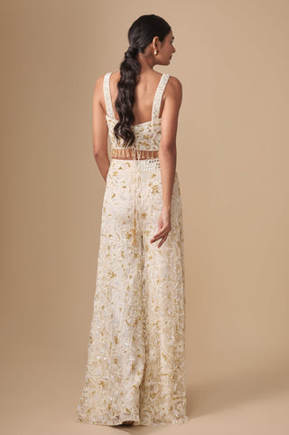 Full-length back view of the corset blouse with wide straps and lace-up back above the floral sharara by Asaga at Mrs. G