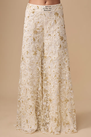 Close-up of the floral jaal sharara with a mirror-embroidered waistband in ivory and gold by Asaga at Mrs. G