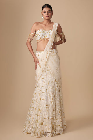 Full-length front view of the ivory gold fish-cut pre-draped saree with tassel pallu and off-shoulder blouse by Asaga at Mrs. G