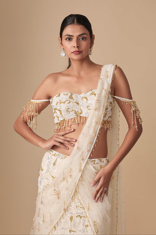 Waist-up view of the off-shoulder sweetheart blouse with beaded tassel sleeves and net pallu on the shoulder by Asaga at Mrs. G