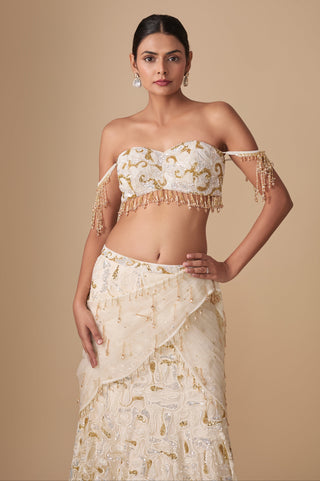 Waist-up view of the beaded tassel blouse with the net draped across the embroidered skirt by Asaga at Mrs. G