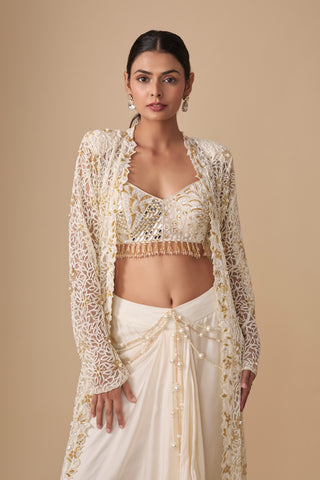 Waist-up view of the cutwork net jacket, mirror embroidered blouse with tassel hem and pearl waist chains by Asaga at Mrs. G