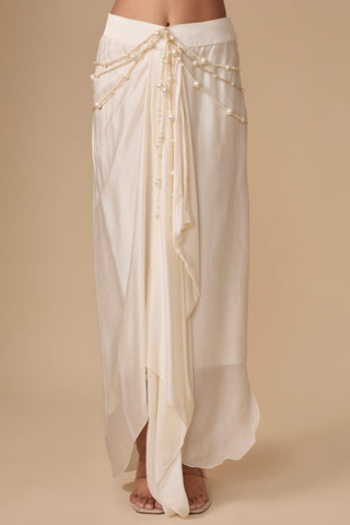 Close-up of the draped satin skirt with strands of pearls and gold chains at the waist by Asaga at Mrs. G