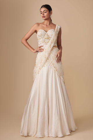 Full-length front view of the ivory gold strapless corset blouse with pre-draped satin saree and net tassel pallu by Asaga at Mrs. G