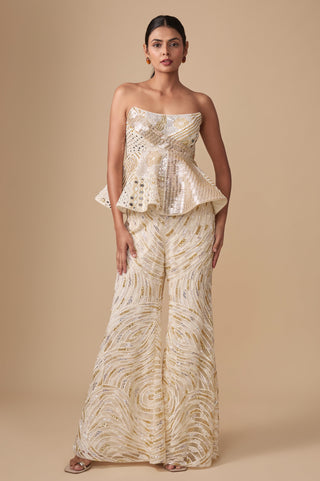Full-length front view of the ivory gold strapless peplum with mirror work and flared sharara by Asaga at Mrs. G