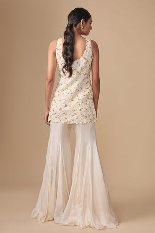 Full-length back view of the ivory gold kurti with scalloped scooped back and satin organza sharara by Asaga at Mrs. G