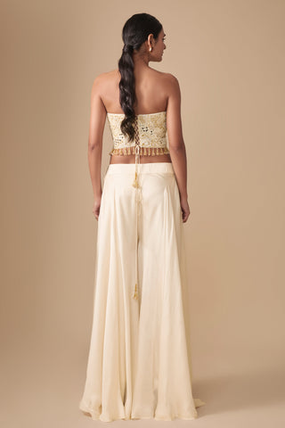 Full-length back view of the corset blouse with lace-up back and tassel cords above the wide sharara by Asaga at Mrs. G