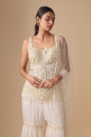 Waist-up view of the scoop-neck kurti with gold palm-leaf embroidery, mirror pieces and beaded hem by Asaga at Mrs. G