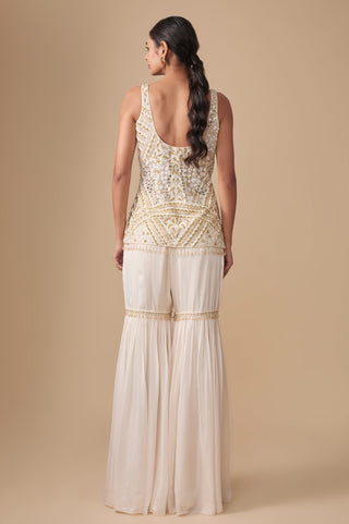 Full-length back view of the ivory gold kurti with scooped back and gathered sharara by Asaga at Mrs. G