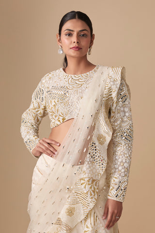 Waist-up view of the full-sleeve embroidered blouse with mirror pieces and net pallu on the shoulder by Asaga at Mrs. G