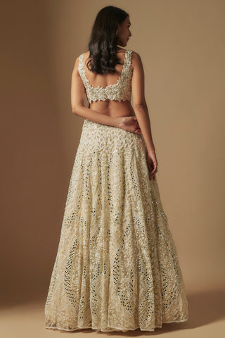 Back view of ivory scoop-back blouse and full flared mirror work lehenga by Asaga at Mrs. G