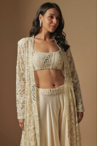 Waist-up close-up of ivory square-neck mirror work blouse under an openwork floral jacket by Asaga at Mrs. G