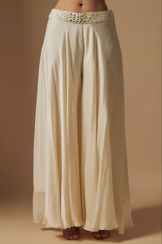 Waist-down view of ivory flowing wide-leg sharara with a mirror and pearl waistband by Asaga at Mrs. G