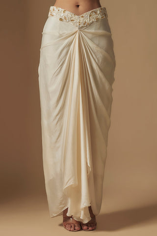 Waist-down view of ivory satin drape skirt knotted at the center with an embroidered waistband by Asaga at Mrs. G