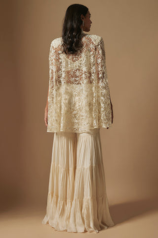 Back view of the sheer ivory embroidered cape over a tiered crinkled satin sharara by Asaga at Mrs. G