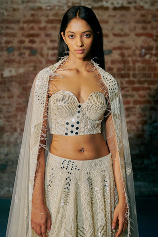 Waist-up view of the ivory mirror bustier and the feather-trimmed sheer dupatta over the shoulders by Asaga at Mrs. G