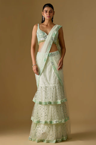 Full-length front view of the mint pre-draped saree with three ruffled net tiers and a mirror work blouse by Asaga at Mrs. G