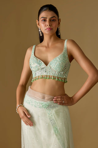 Waist-up close-up of the mint mirror work blouse with a bead tassel fringe and the net pallu by Asaga at Mrs. G