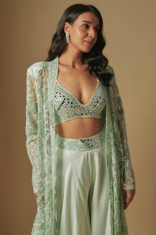 Waist-up close-up of mint V-neck mirror grid blouse under a sheer embroidered jacket by Asaga at Mrs. G