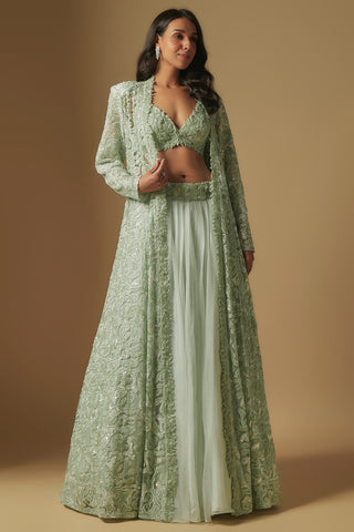 Front view of a mint tonal cutwork floor-length jacket open over an embroidered blouse and flared skirt by Asaga at Mrs. G