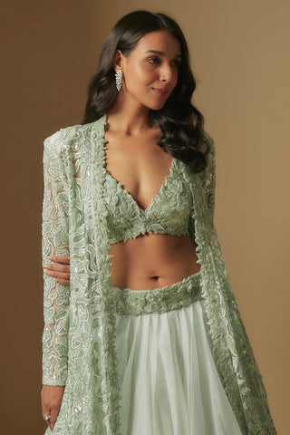 Waist-up view of the mint plunging knotted blouse and full-sleeve cutwork jacket by Asaga at Mrs. G