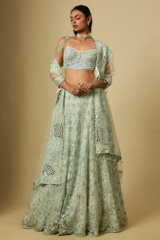 Front view of a mint floral sequin embroidered lehenga with a chain strap blouse and net dupatta by Asaga at Mrs. G
