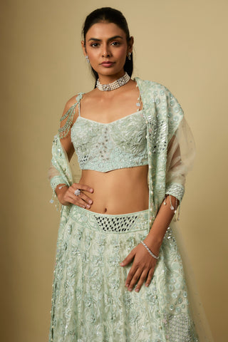 Waist-up view of the mint bustier blouse with drop chains, mirror waistband and net dupatta by Asaga at Mrs. G