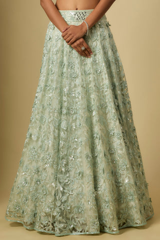 Waist-down view of the mint lehenga with floral vine embroidery and a mirror work waistband by Asaga at Mrs. G