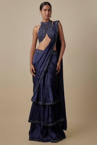 Full-length front view of the navy blue pre-draped saree with ruffled tiers and a halter blouse by Asaga at Mrs. G