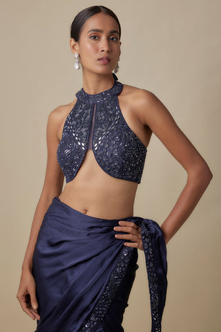 Waist-up view of the navy halter blouse with mirror and thread florals and a draped satin skirt by Asaga at Mrs. G