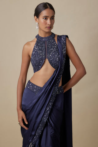 Three-quarter view of the navy satin pallu with an embroidered border crossing the blouse by Asaga at Mrs. G