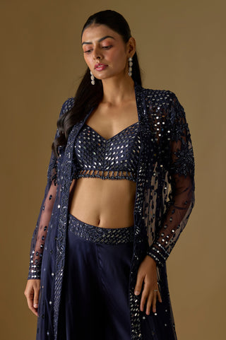 Waist-up close-up of the navy V-neck mirror work blouse with a tassel fringe under the open jacket by Asaga at Mrs. G